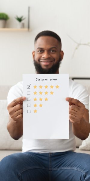 African american man puts five stars at customer review